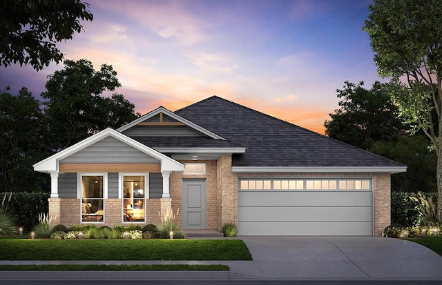 view of front of house with a yard and a garage