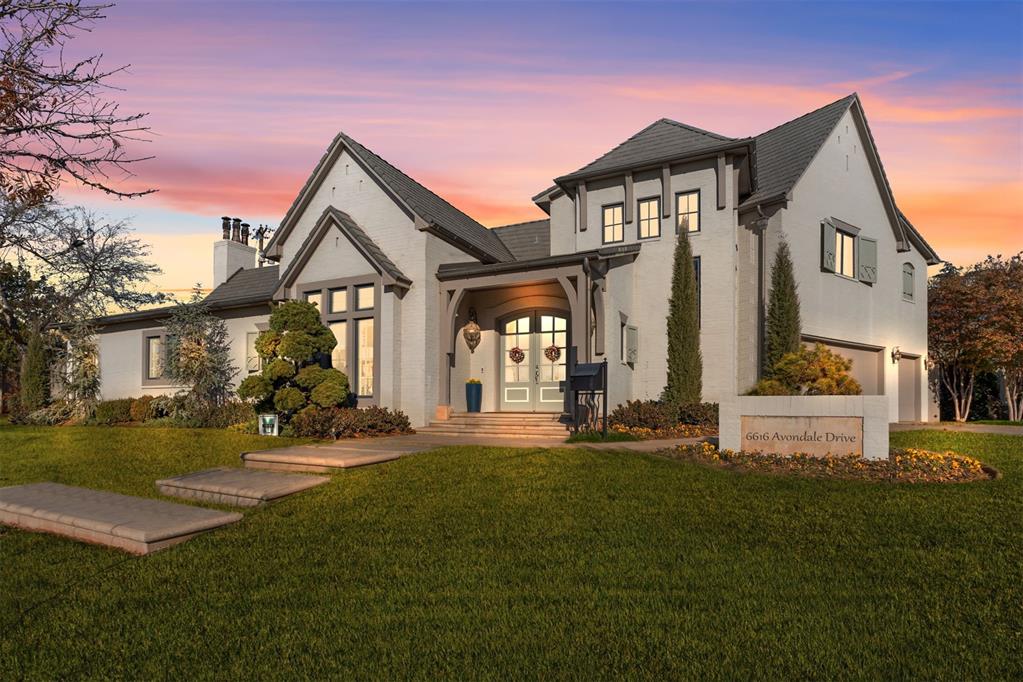 view of front of property with french doors and a lawn