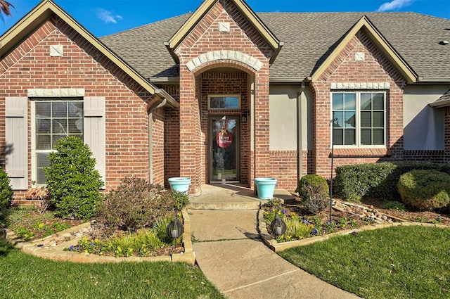 entrance to property featuring a lawn