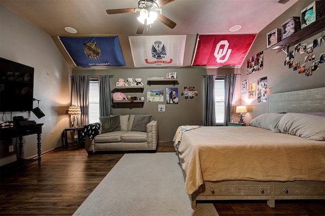 bedroom with ceiling fan, lofted ceiling, and dark wood-type flooring