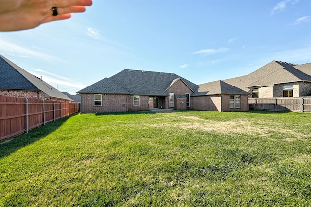 rear view of house featuring a yard