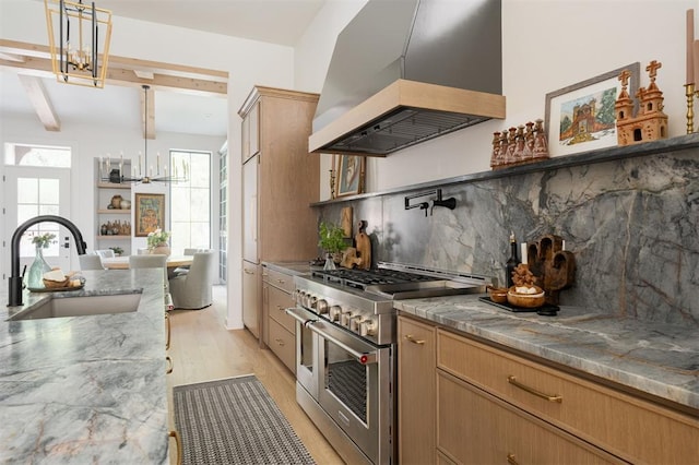 kitchen with sink, light hardwood / wood-style flooring, pendant lighting, double oven range, and custom range hood