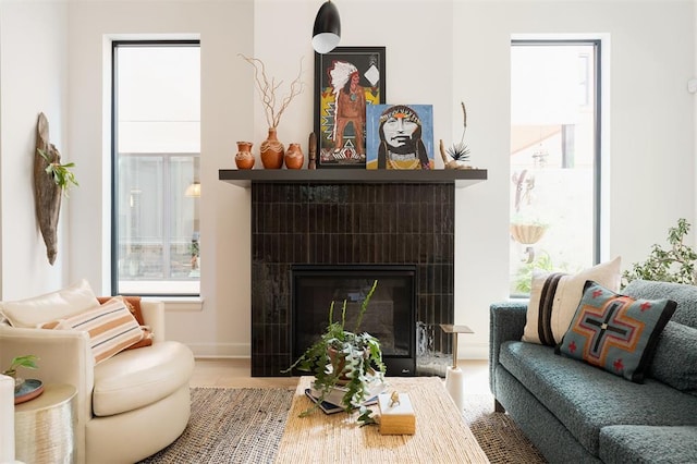 sitting room featuring plenty of natural light and a tiled fireplace