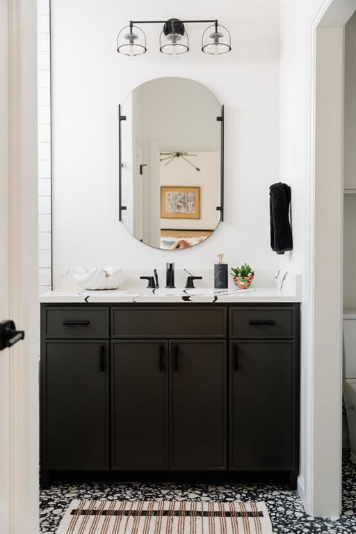 bathroom with vanity, ceiling fan, and toilet