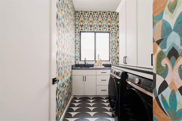 bathroom with washer and clothes dryer and sink