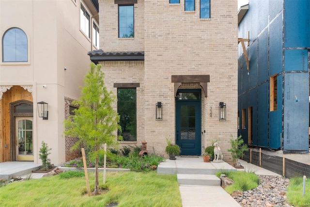 doorway to property featuring a yard