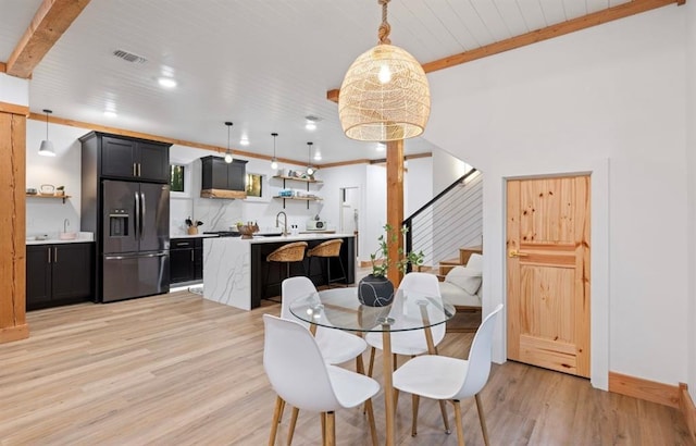 dining room featuring crown molding, sink, wooden ceiling, and light wood-type flooring