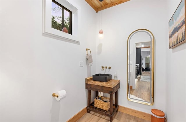 bathroom featuring wood ceiling, sink, and hardwood / wood-style floors