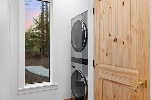 laundry room with stacked washing maching and dryer