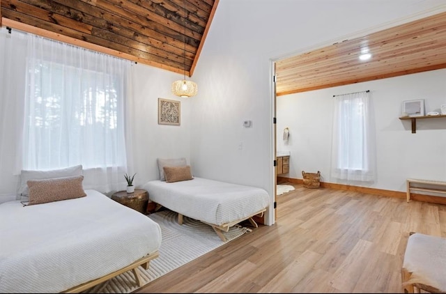 bedroom featuring lofted ceiling, wooden ceiling, and light hardwood / wood-style flooring