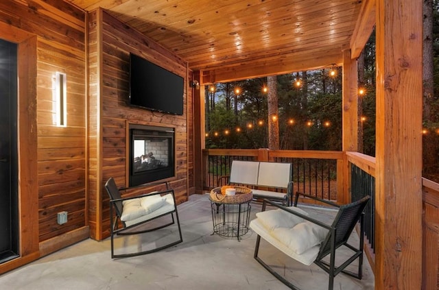 view of patio / terrace featuring a fire pit and a multi sided fireplace