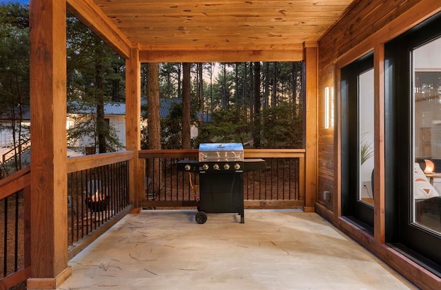 sunroom featuring wood ceiling