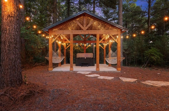 view of patio / terrace featuring a gazebo and a hot tub