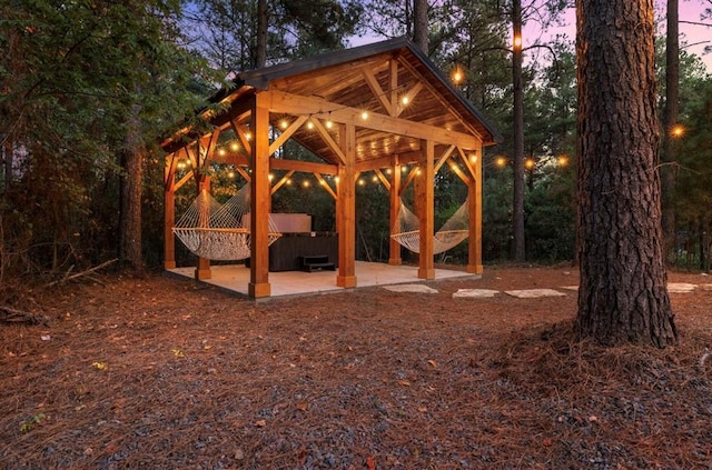 view of home's community featuring a gazebo, a hot tub, and a patio area