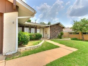 view of exterior entry with a lawn