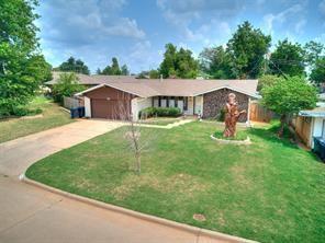 single story home featuring a garage and a front yard