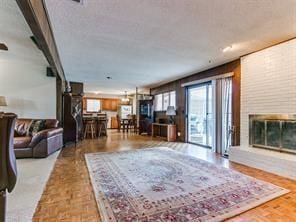 living room with parquet flooring and a brick fireplace