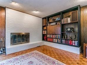 sitting room featuring a fireplace and parquet flooring