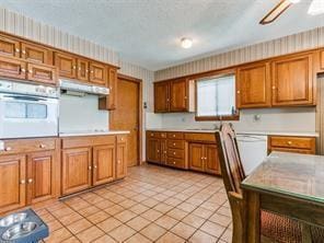 kitchen with white appliances and light tile patterned floors