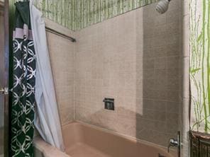 bathroom with shower / bath combination with curtain