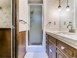 bathroom with vanity, tile patterned floors, and a shower with door