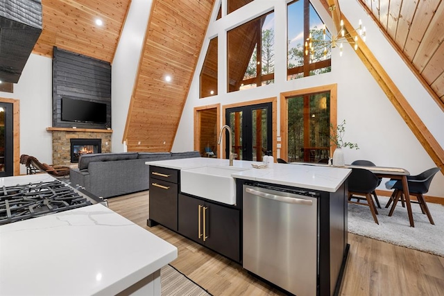 kitchen featuring a center island with sink, dishwasher, wood ceiling, and high vaulted ceiling