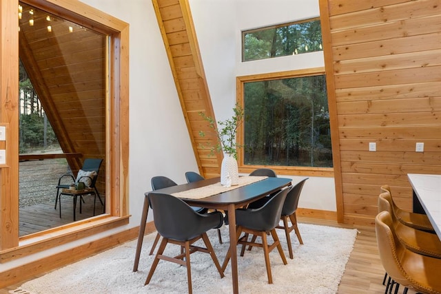 dining area featuring wood ceiling, a wealth of natural light, and light hardwood / wood-style floors