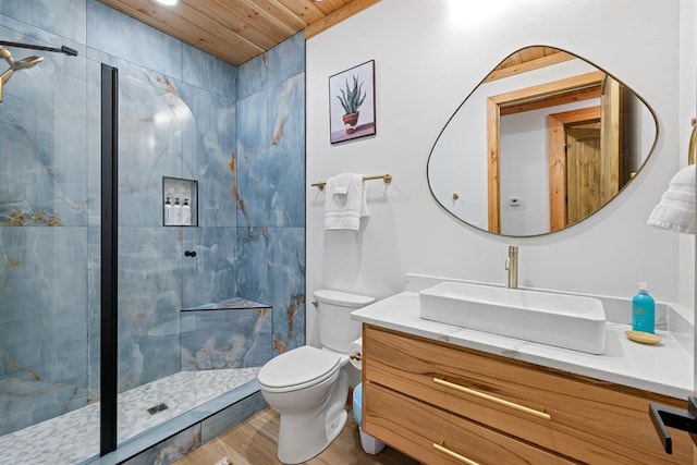 bathroom with wood ceiling, vanity, tiled shower, wood-type flooring, and toilet