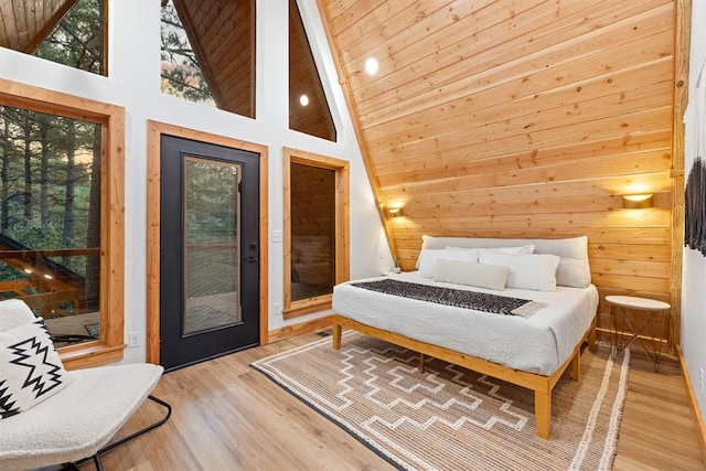 bedroom featuring access to exterior, hardwood / wood-style floors, high vaulted ceiling, and wood ceiling