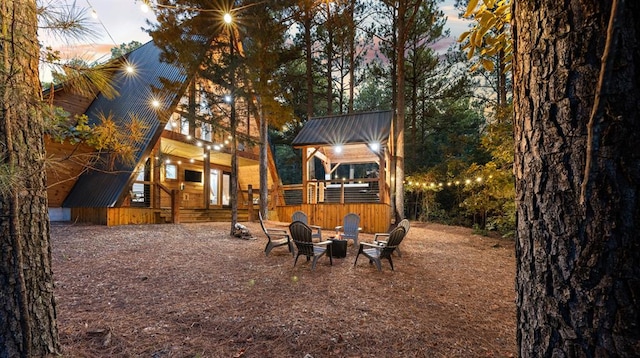 yard at dusk featuring a fire pit