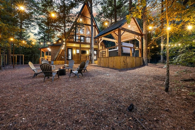 back house at dusk with a fire pit