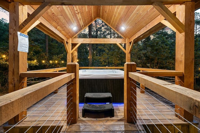 wooden deck with a hot tub