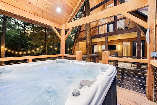 wooden terrace featuring a hot tub