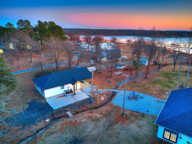 aerial view at dusk with a water view