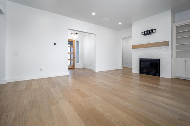 unfurnished living room featuring light hardwood / wood-style floors