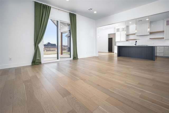 unfurnished living room with light wood-type flooring