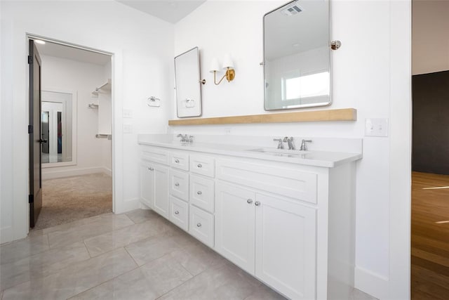 bathroom featuring tile patterned flooring and vanity