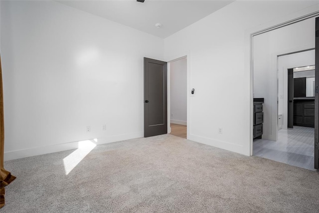 unfurnished bedroom featuring light carpet