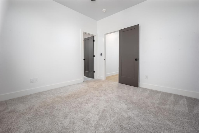 unfurnished bedroom featuring light colored carpet