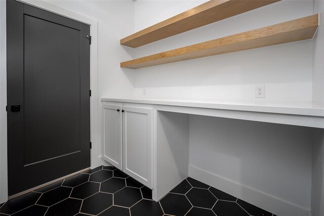 interior space featuring dark tile patterned flooring