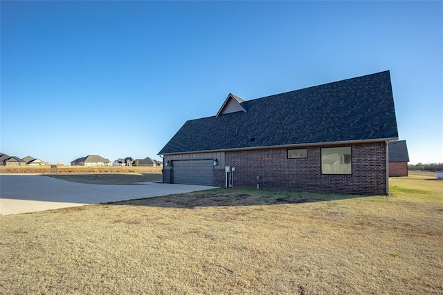 view of home's exterior with a yard and a garage