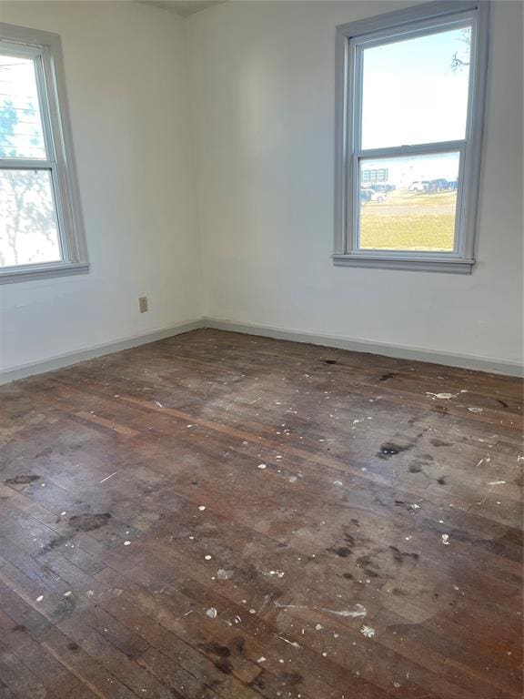 unfurnished room featuring dark wood-type flooring