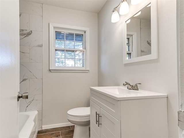 full bathroom with vanity, tiled shower / bath combo, and toilet