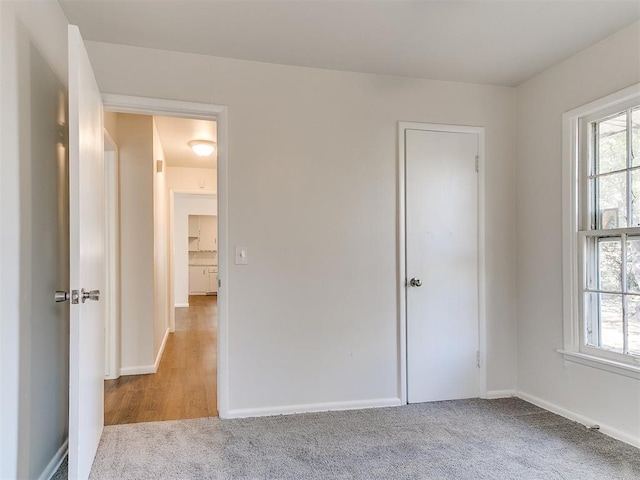 unfurnished room featuring light carpet