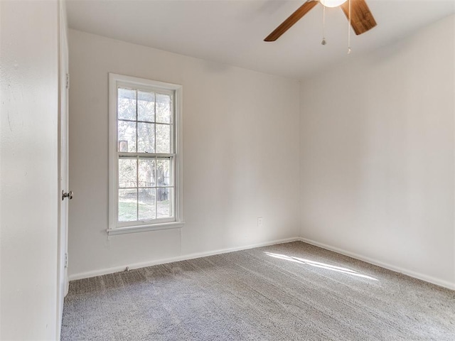 empty room with ceiling fan and carpet floors