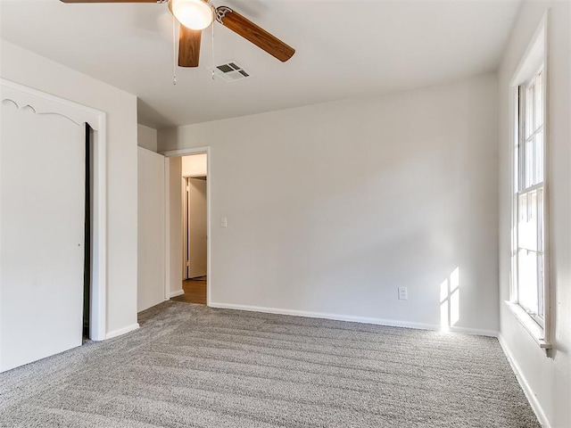 unfurnished bedroom featuring light colored carpet and ceiling fan