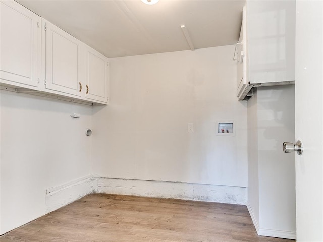 washroom with cabinets, light wood-type flooring, and hookup for a washing machine