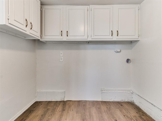 washroom featuring hardwood / wood-style floors and cabinets