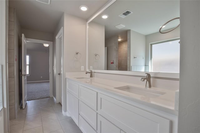 bathroom with tile patterned flooring, vanity, and a wealth of natural light