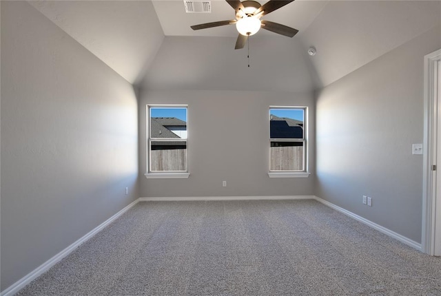 carpeted spare room with ceiling fan and vaulted ceiling